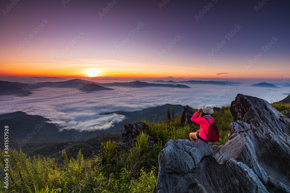 Young girl in red jacket hiking on the mountain, Doy-pha-tang, border  of  Thailand and Laos.
