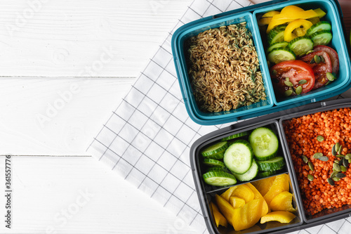 Lunch box with cooked buckwheat and fresh vegetable salad