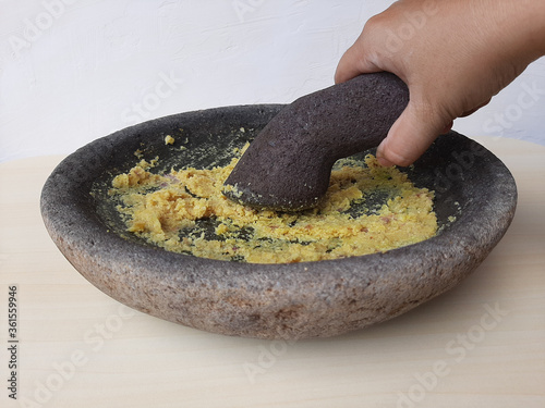 Mashed seasoning, from garlic, candlenut, salt and pepper. Handmade, traditionally made with stone mortar. Basic seasoning for various Indonesian cuisine