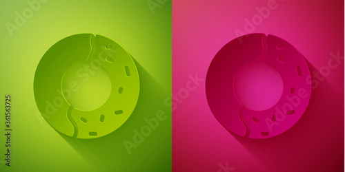 Paper cut Donut with sweet glaze icon isolated on green and pink background. Paper art style. Vector Illustration.