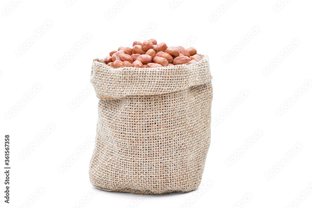 Peanuts raw grains in a sack of on white background