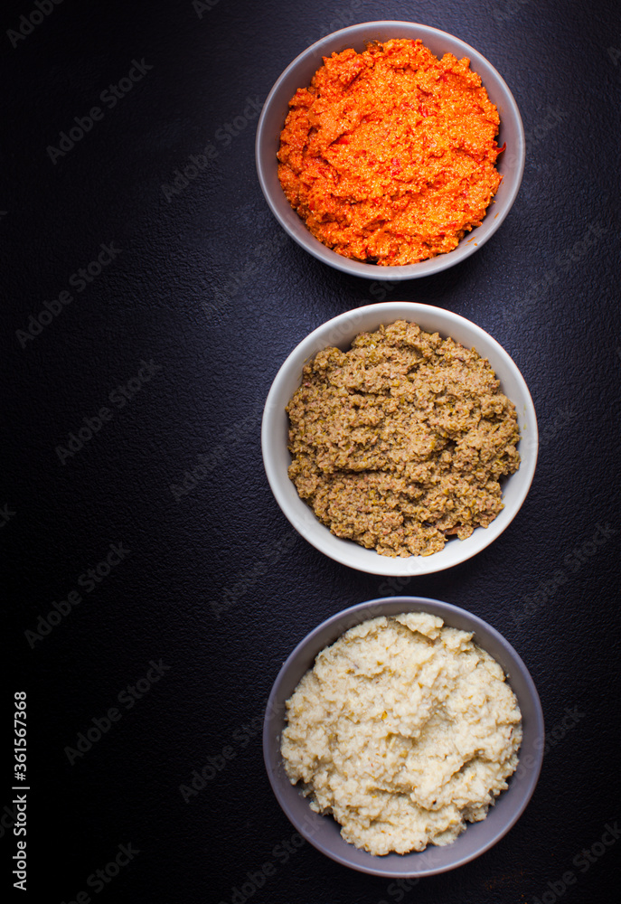 Plates with assortment of spreads, healthy snack Plates with assortment of spreads, healthy snack