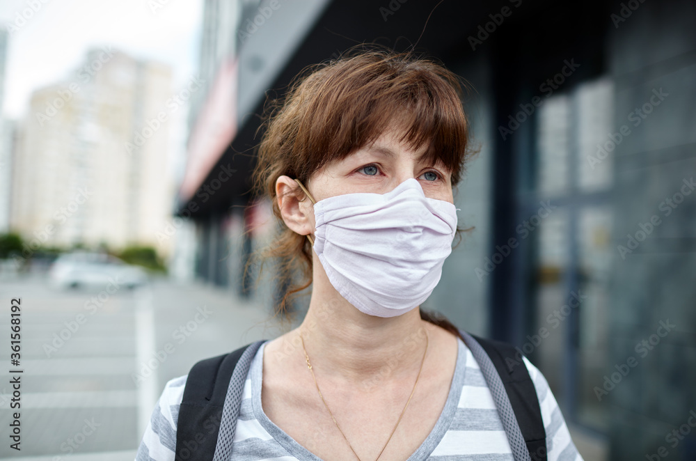 Woman wearing hygienic mask to prevent the Coronavirus. People in masks The outbreak of Novel Corona virus (2019-nCoV) in Europe. Concept of coronavirus quarantine. Air pollution Woman wearing hygienic mask to prevent the Coronavirus. People in masks The outbreak of Novel Corona virus (2019-nCoV) in Europe. Concept of coronavirus quarantine. Air pollution