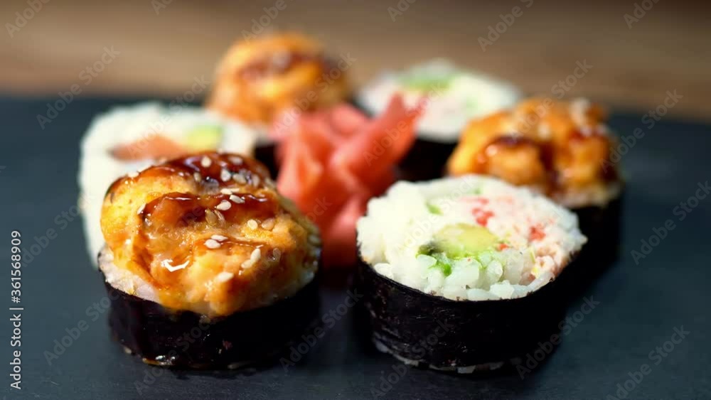 Sushi roll set on the black plate. Japanese food.