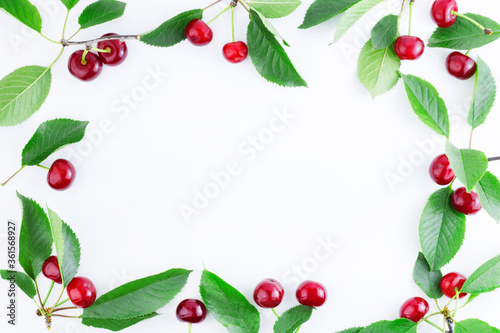 Frame of ripe cherries with leaves. Summer background. Ripe sweet cherries isolated on a white background. Copy space