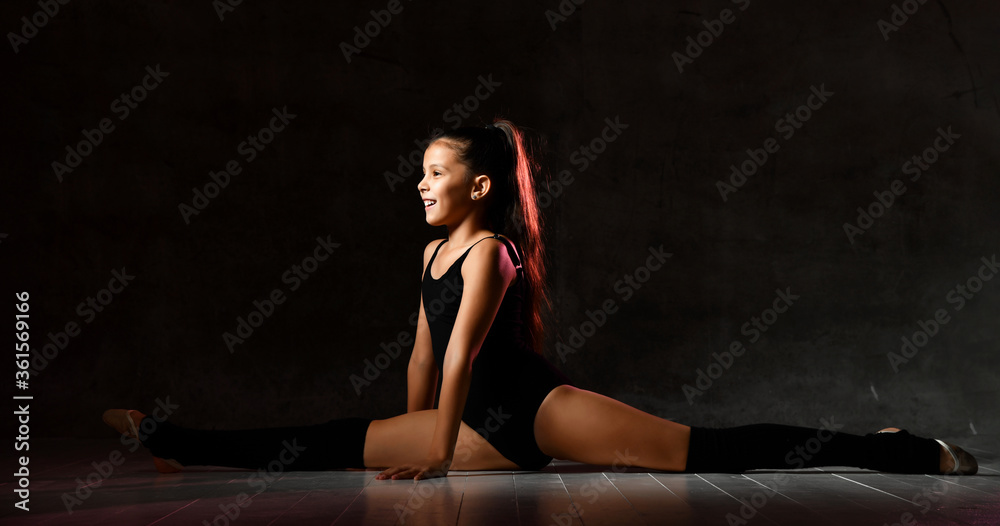 Young gymnast girl stretching and training