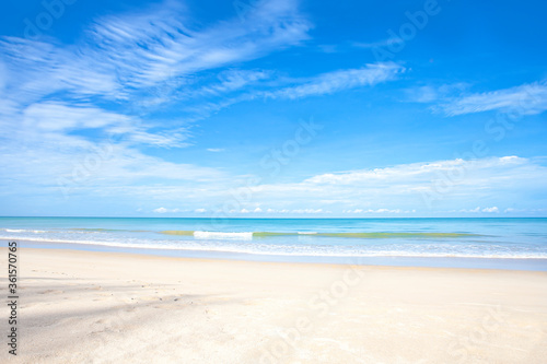 landscape of white sand beach with blue sea and cloudy blue sky background for summer travel concept.