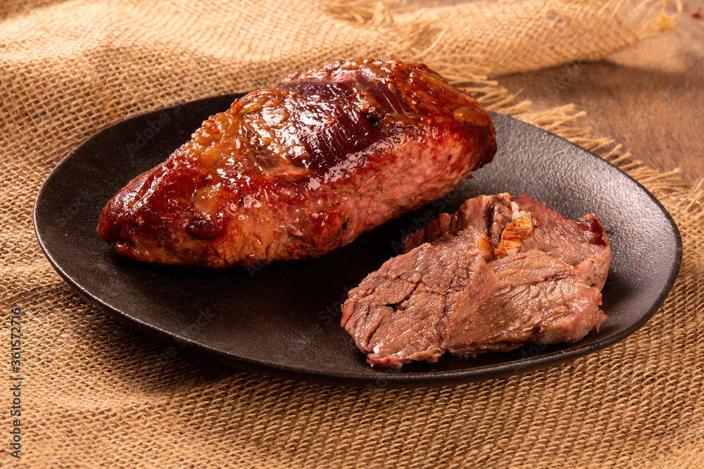 Hot Grilled Whole Tri-tip Steak or rump skirt on a plate