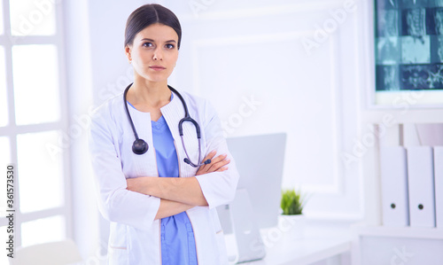 Young smiling female doctor with stethoscope at doctor's office
