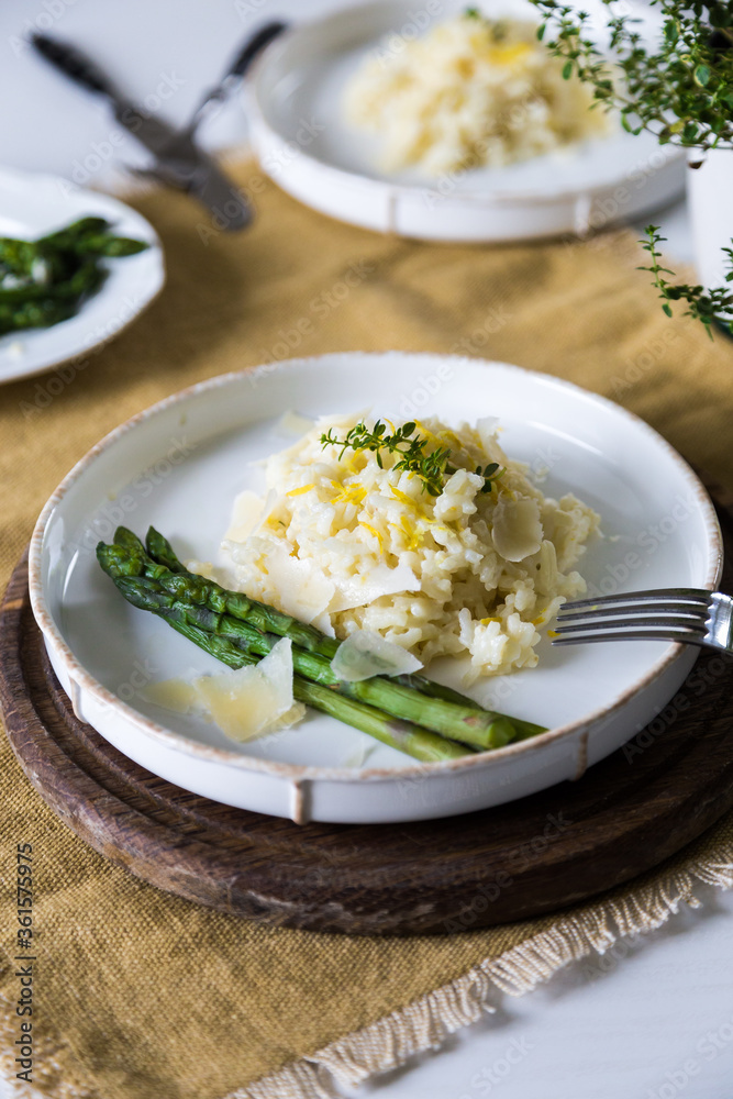 Creamy lemon risotto with parmesan and asparagus on white plate. Creamy lemon risotto with parmesan and asparagus on white plate.