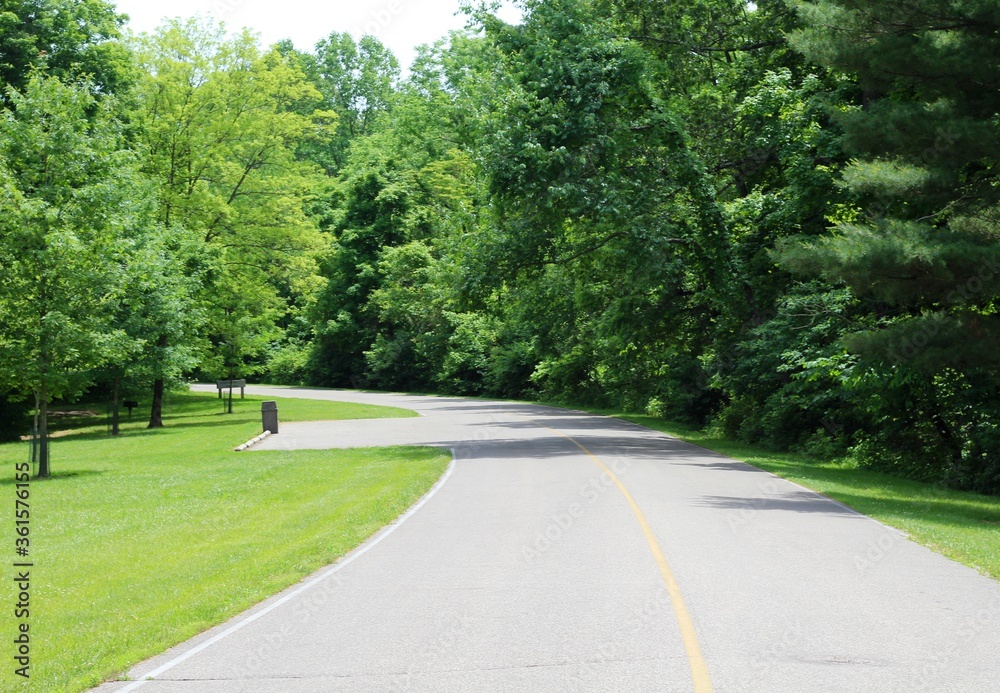 A view of the empty road in the country on a sunny day. A view of the empty road in the country on a sunny day.