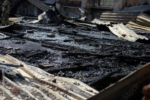 Burned house interior after fire, ruined building room inside, disaster or war aftermath