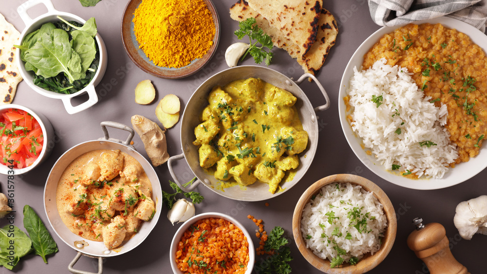 assorted of indian meal- curry dish, dahl, chicken, naan