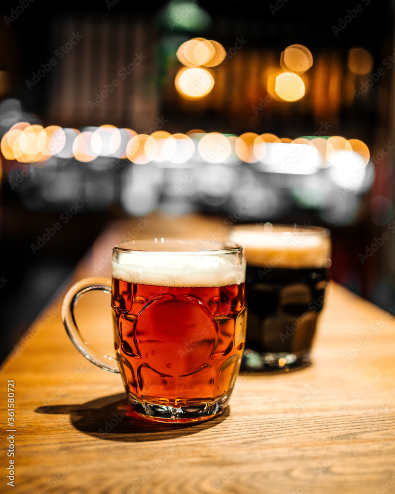 Mugs of craft beer at bar with blurry background