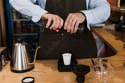 Aeropress coffee alternative making by barista in the cafe. Barista connect details from aeropress together. prepare aeropress to pour it. Advert for cafe, restaurants.