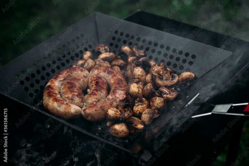 Grilled chicken sausage with mushrooms in a pan Grilled chicken sausage with mushrooms in a pan