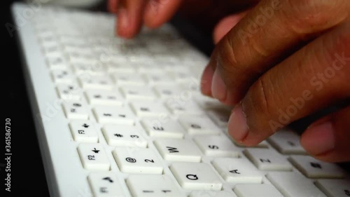His hand working with computer and mouse keyboard