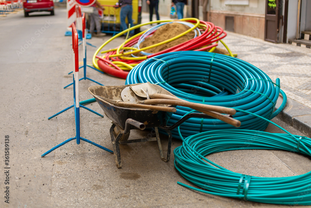 Repair work on city streets. Laying cable routes. Coils of plastic casings Repair work on city streets. Laying cable routes. Coils of plastic casings