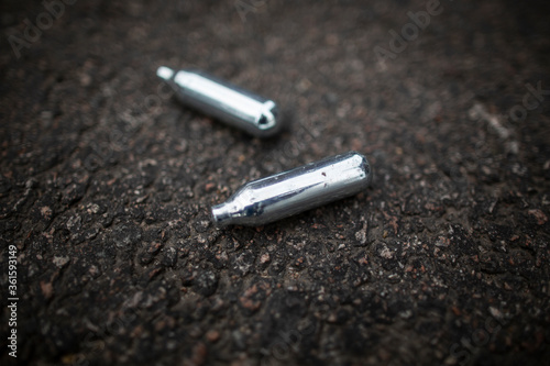 Картината върху платно Nitrous Oxide Canisters Litter On Floor Close Up