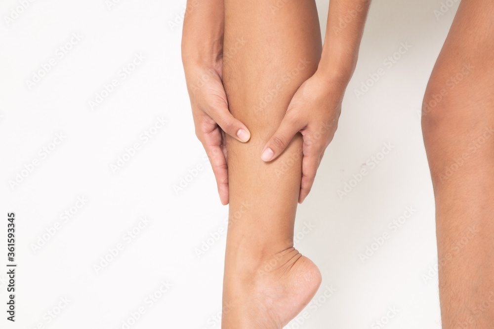 woman suffering from leg pain, calf pain. mono tone highlight at calf, leg isolated on white background. health care and medical concept