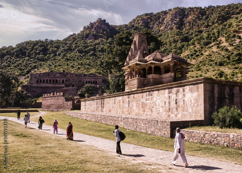 Rajasthan, India - October 06, 2012: People walking in distance around abandoned cursed ruined fort in a place named Ajabgarh on a way to allegedly haunted place Bhangarh fort photo