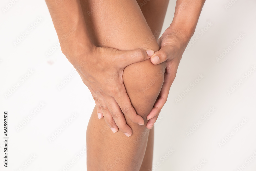 Pain in woman knee. Female holding hands on spot pain , Isolated on white background