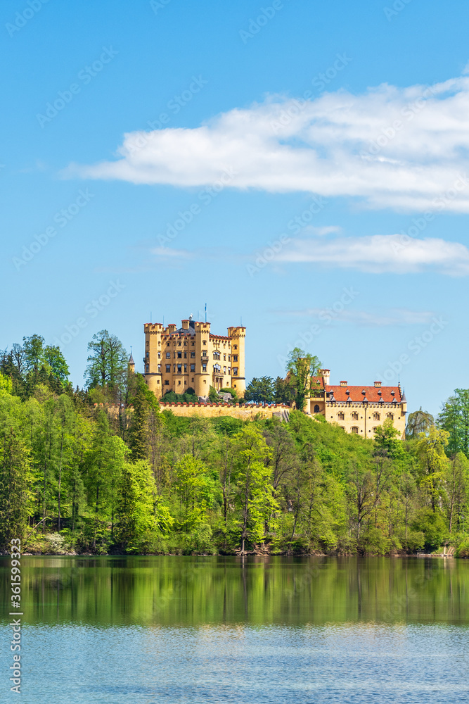 View of Hohenschwangau Castle from the lake on a sunny day. Germany, Bavaria, Schwangau.