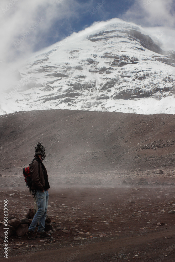 Man is Looking the snowed Mountain Top of Chimborazo, the highest mountain in Ecuador, in the Andes Mountain Range