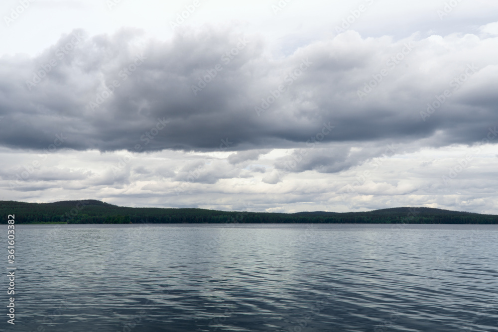 view of the lake and cumulus clouds