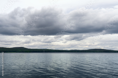 view of the lake and cumulus clouds © Анна Майорова