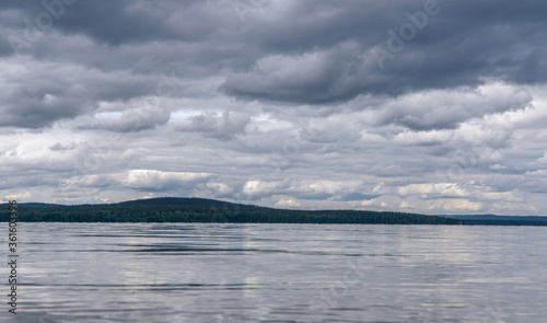 view of the lake and cumulus clouds