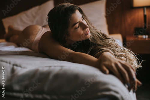 Young woman in lingerie lying on the bed