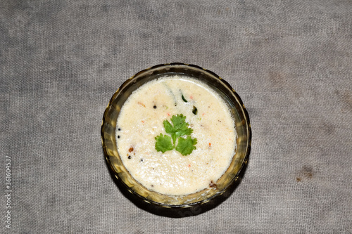 south indian cuisine - White coconut chutney served in a glass bowl.