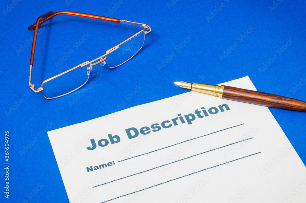 Job description template on the blue office desk with pen Job description template on the blue office desk with pen