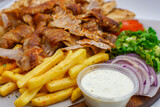 Greek / Arabic Lamb / Pork Meat with Fries / Chips Tzatziki Salad Tomatoes Onions Lettuce