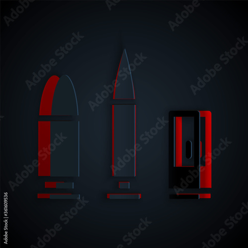 Paper cut Bullet and cartridge icon isolated on black background. Paper art style. Vector.