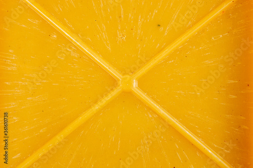 close-up texture and background of yellow bakelite or carbolite plastic material with x-shaped mold reinforcement ribs photo