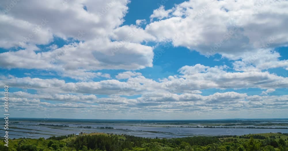 Beautiful summer landscape of the valley with a river. View from the hill. Noon. The wind stirs the grass and branches of trees Beautiful summer landscape of the valley with a river. View from the hill. Noon. The wind stirs the grass and branches of trees