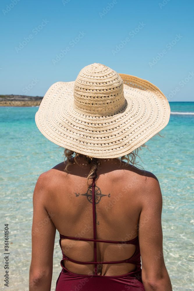 Woman with Tattoo looking toward Tropical Water