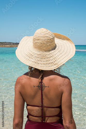 Woman with Tattoo looking toward Tropical Water