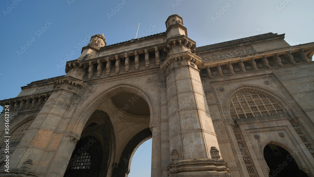 Gate of India in Mumbai against a blue sky.