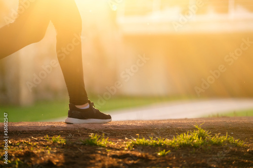 woman runner while running, blurred backlight motion practicing sport fitness and healthy lifestyle concept