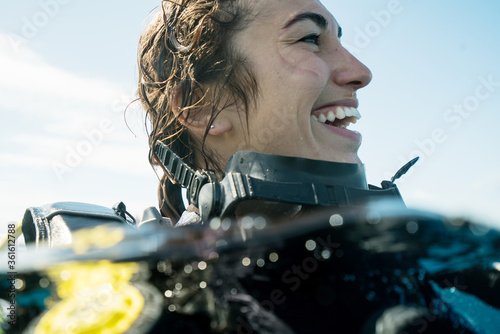 Woman Smiling while Scuba Diving with joyful toothy grin during tropical underwater adventure with mask 