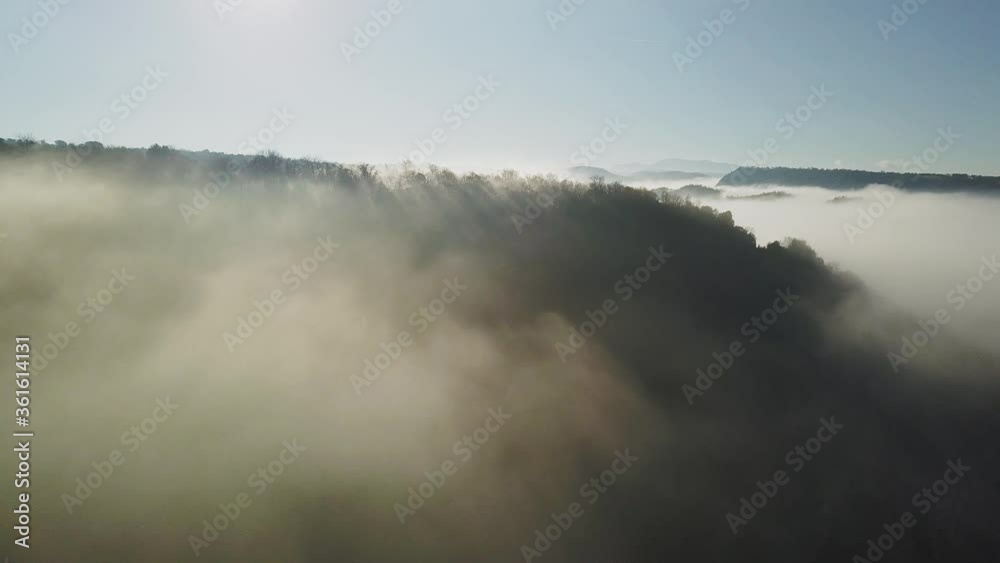 Aerial view of thick clouds of fog surrounding forest, zooming out shot
Aerial view of thick clouds of fog surrounding forest, zooming out shot