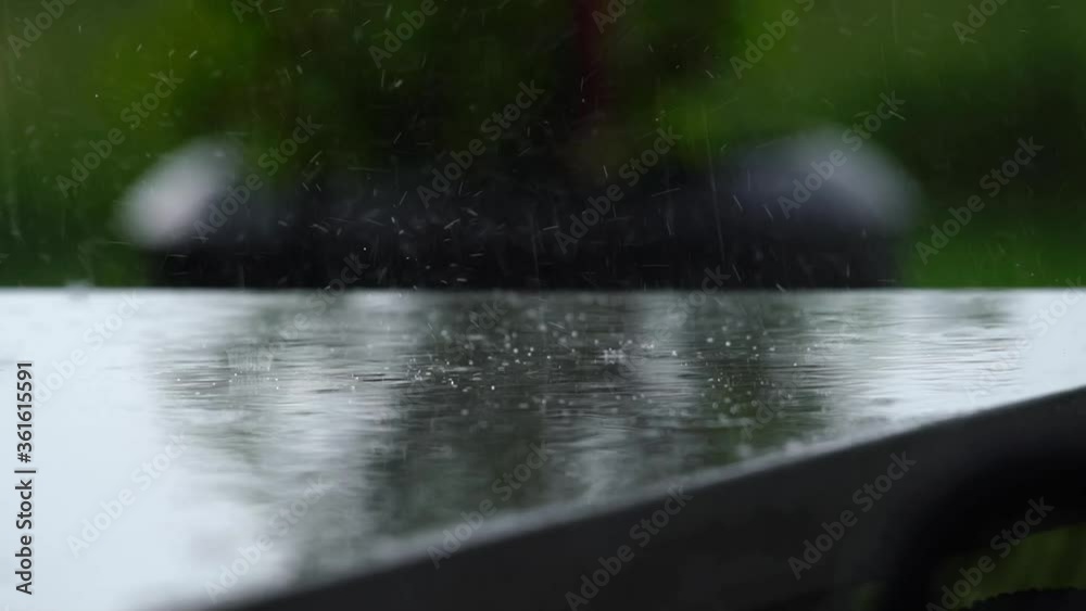 Rain falling in slowmotion on a concrete table Rain falling in slowmotion on a concrete table