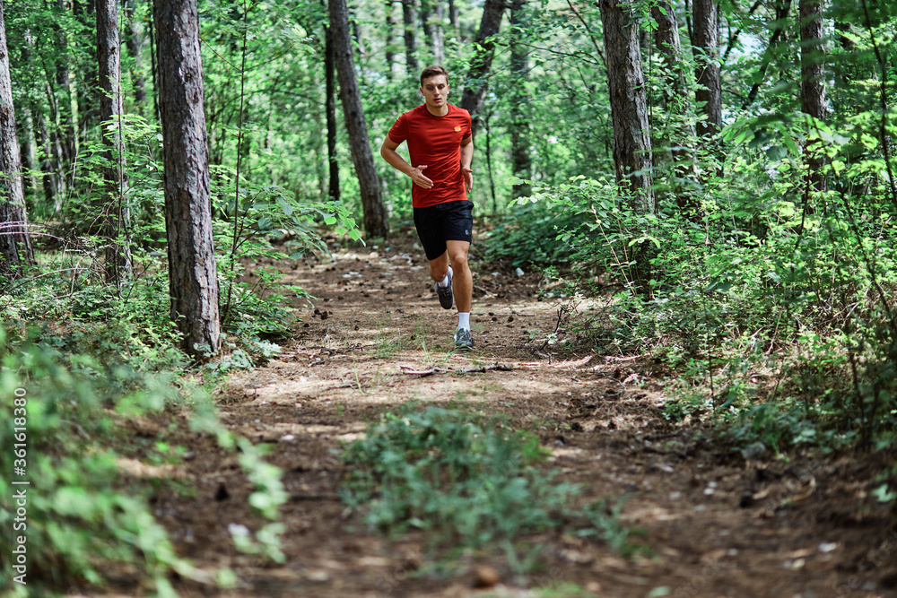 Young man running alone on an empty road Young man running alone on an empty road