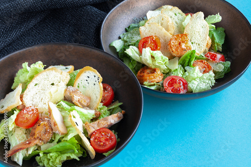 Classic shrimp caesar salad with romaine leaves, croutons, parmesan, tomatoes