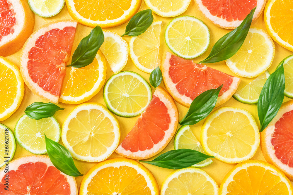 Sliced grapefruit, orange, lemon and lime. The concept of citrus fruits, vegetarianism, healthy fruits. Bright background image.
