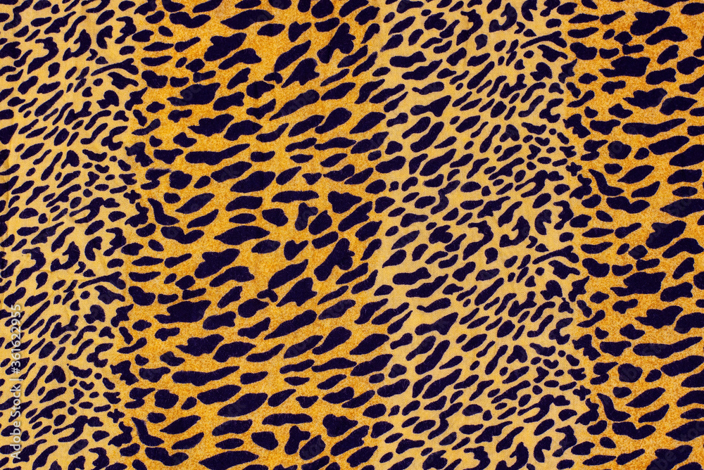Durable patterned fabric, leopard print, black spots on a yellow-orange background Durable patterned fabric, leopard print, black spots on a yellow-orange background