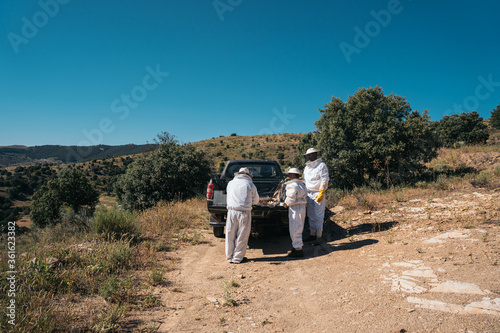Beekeepers preparing material to go collect honey from the honeycombs 